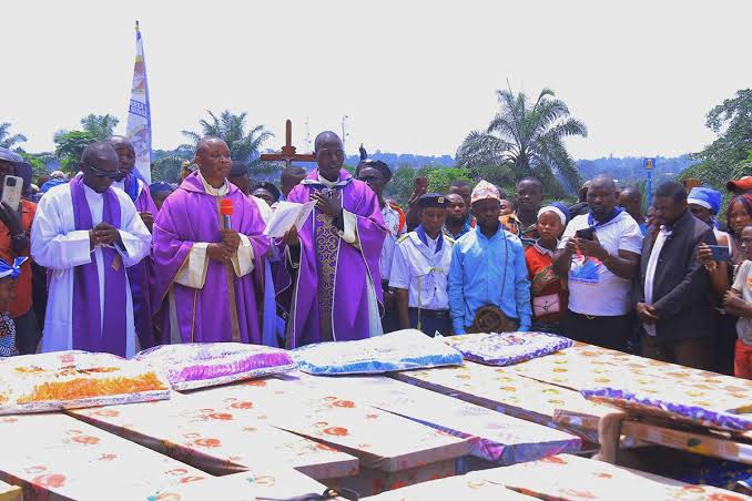 Community members mourn victims of the Komanda church massacre