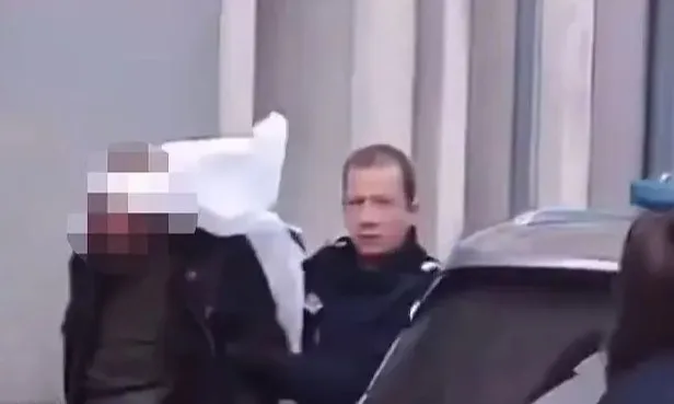 Police arresting the attacker.